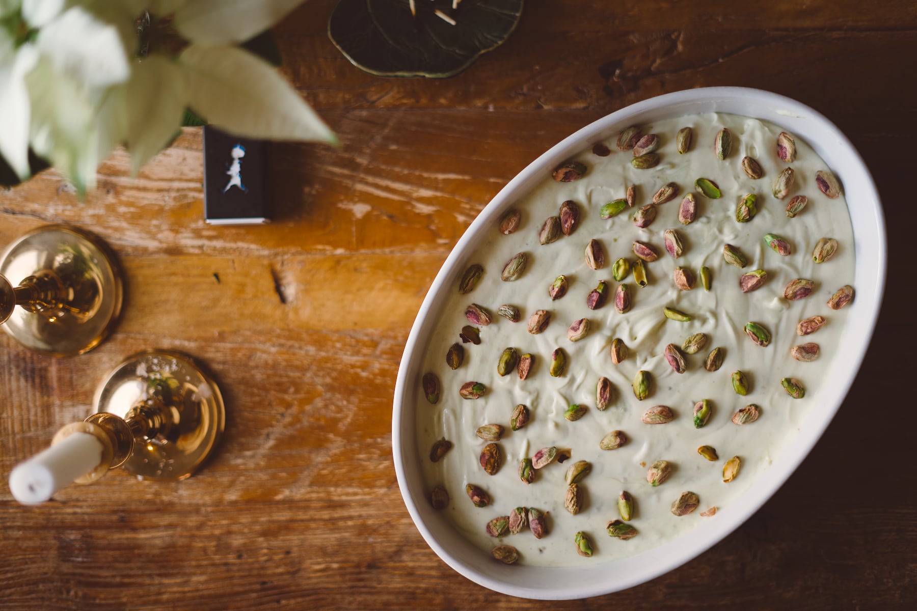 Light green, creamy ice cream, sprinkled with crunchy pistachio nuts, ready to head straight into the freezer.