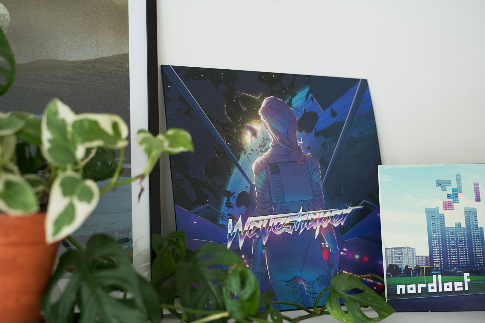Vinyl album with the title Waveshaper. A woman looking out on a body floating in space from her ship. She has an NES on her back, and a Nintendo Zapper strapped to her leg. The setting is very neon.