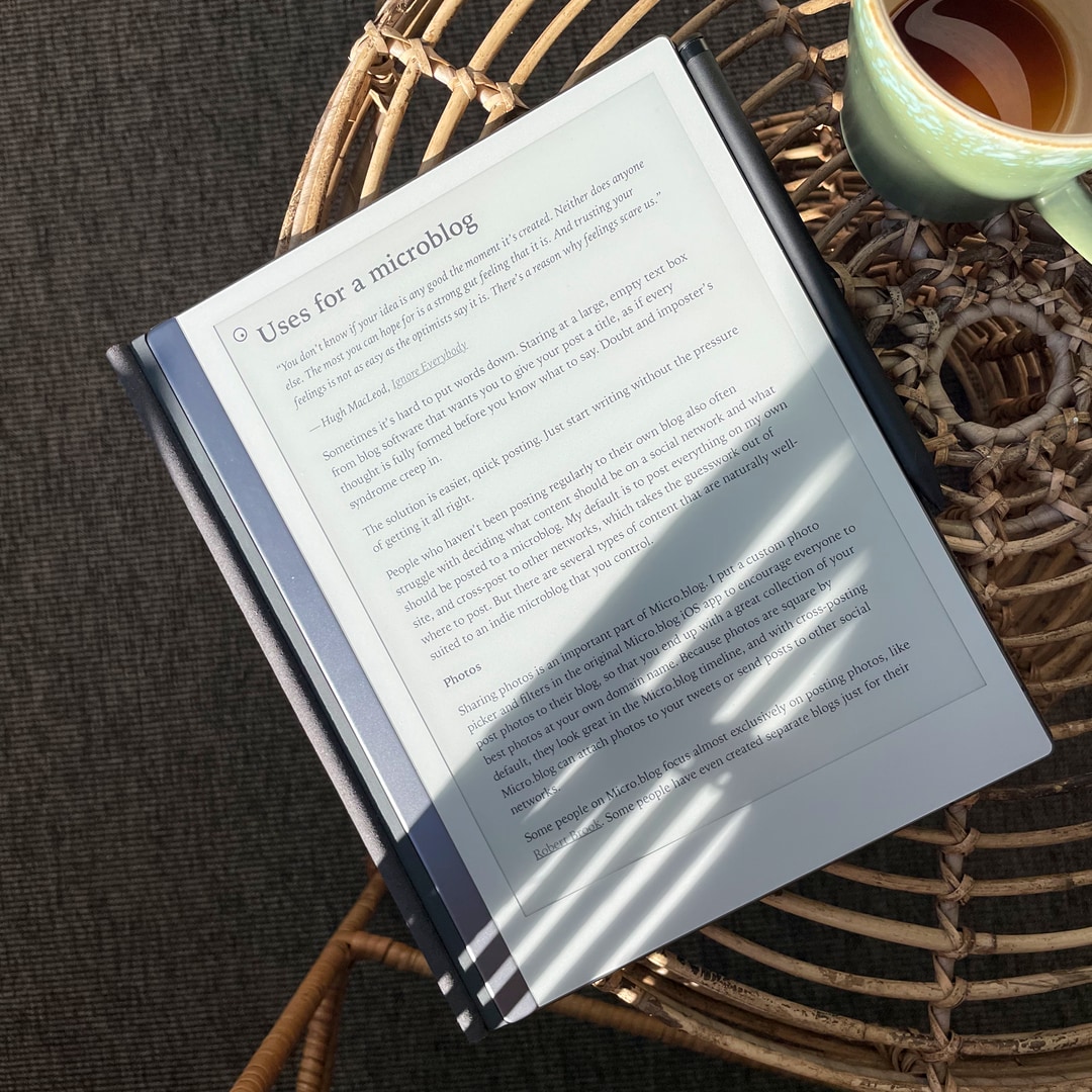 E-book reader lying on a coffee table in the sun. The chapter title reads Uses for a microblog.